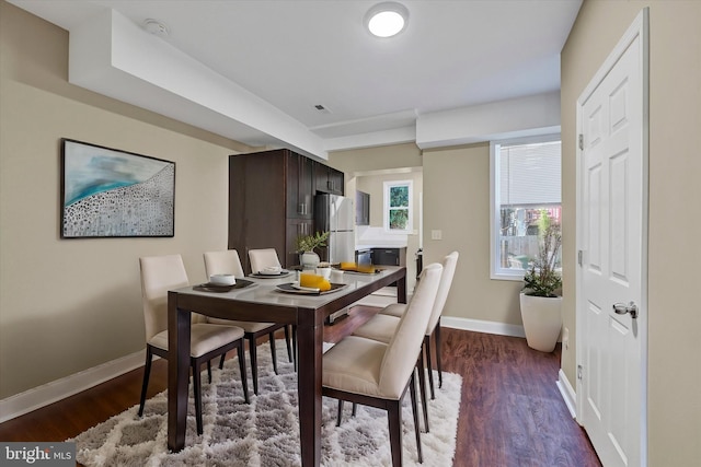 dining area with dark wood-type flooring