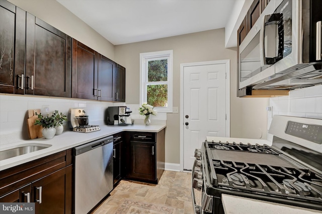 kitchen featuring decorative backsplash, dark brown cabinets, and stainless steel appliances