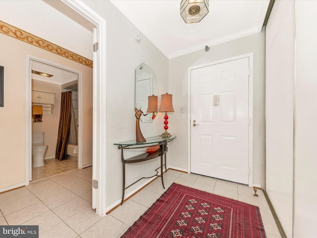 tiled foyer entrance featuring crown molding