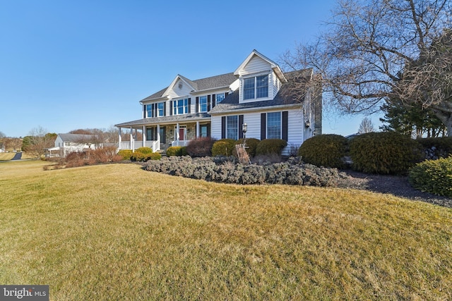 view of front of property featuring covered porch and a front yard