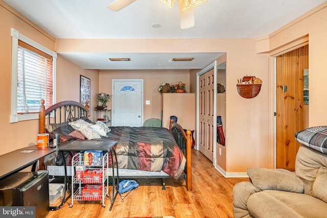 bedroom featuring baseboards, visible vents, and wood finished floors