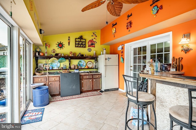 kitchen with french doors, freestanding refrigerator, and ceiling fan