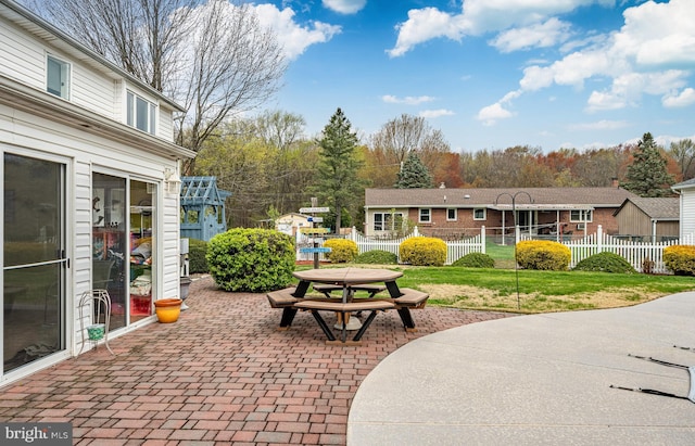 view of patio with fence and outdoor dining space