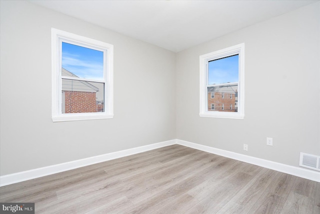 unfurnished room with light hardwood / wood-style flooring