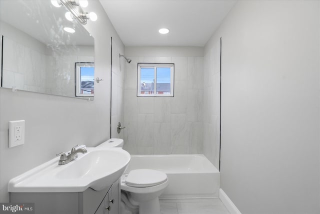 full bathroom with vanity, tiled shower / bath, and toilet