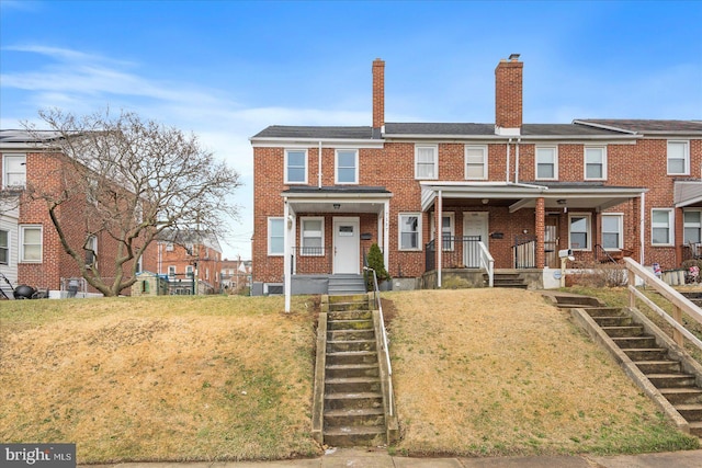 view of property with a porch and a front yard