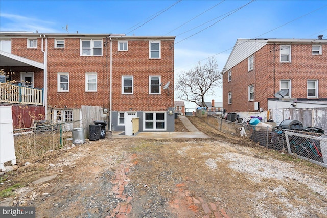 back of house featuring central AC unit