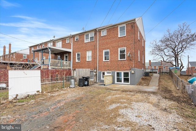 rear view of property with central AC unit