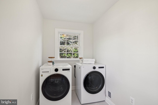 clothes washing area with washing machine and dryer