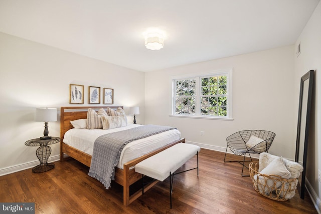 bedroom with dark hardwood / wood-style flooring