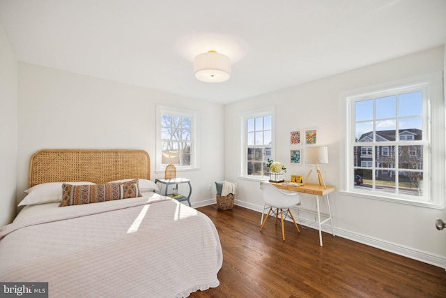 bedroom with dark wood-type flooring