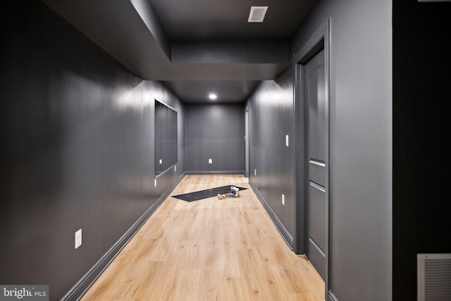 hallway with light hardwood / wood-style flooring