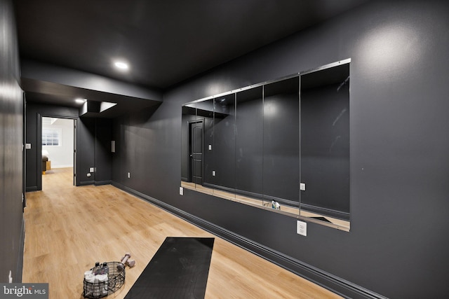 workout area featuring light wood-type flooring