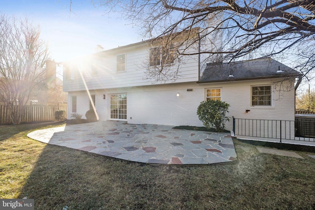 back of property with a yard, a patio area, and central air condition unit