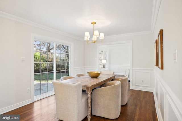 dining space featuring ornamental molding, dark wood-type flooring, and a chandelier