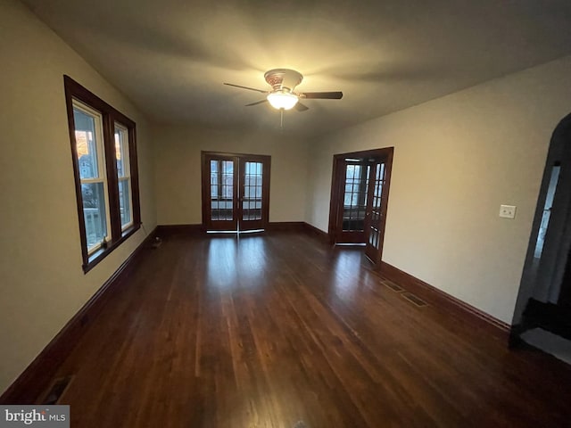 spare room with french doors, ceiling fan, and dark hardwood / wood-style flooring