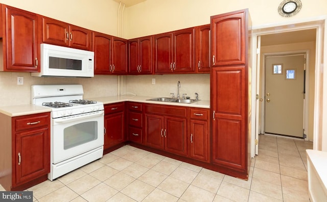 kitchen featuring tasteful backsplash, sink, white appliances, and light tile patterned flooring