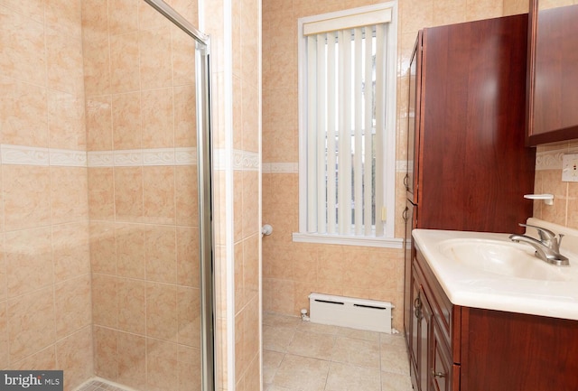 bathroom featuring a baseboard radiator, vanity, a shower with shower door, and tile patterned floors