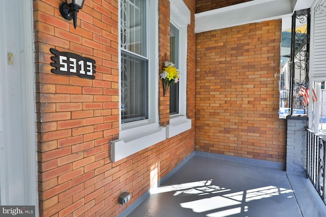 view of exterior entry featuring covered porch