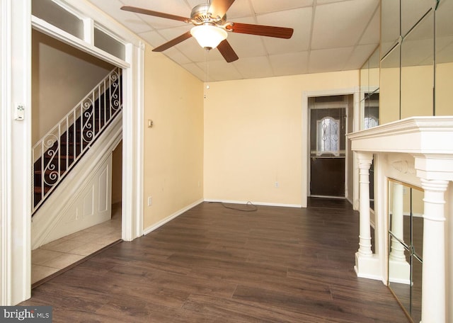 unfurnished room with dark wood-type flooring, a paneled ceiling, and ceiling fan