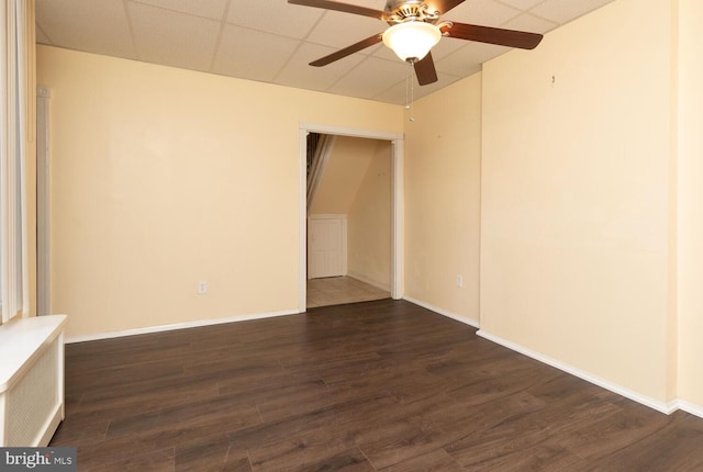 unfurnished room featuring dark hardwood / wood-style floors and ceiling fan