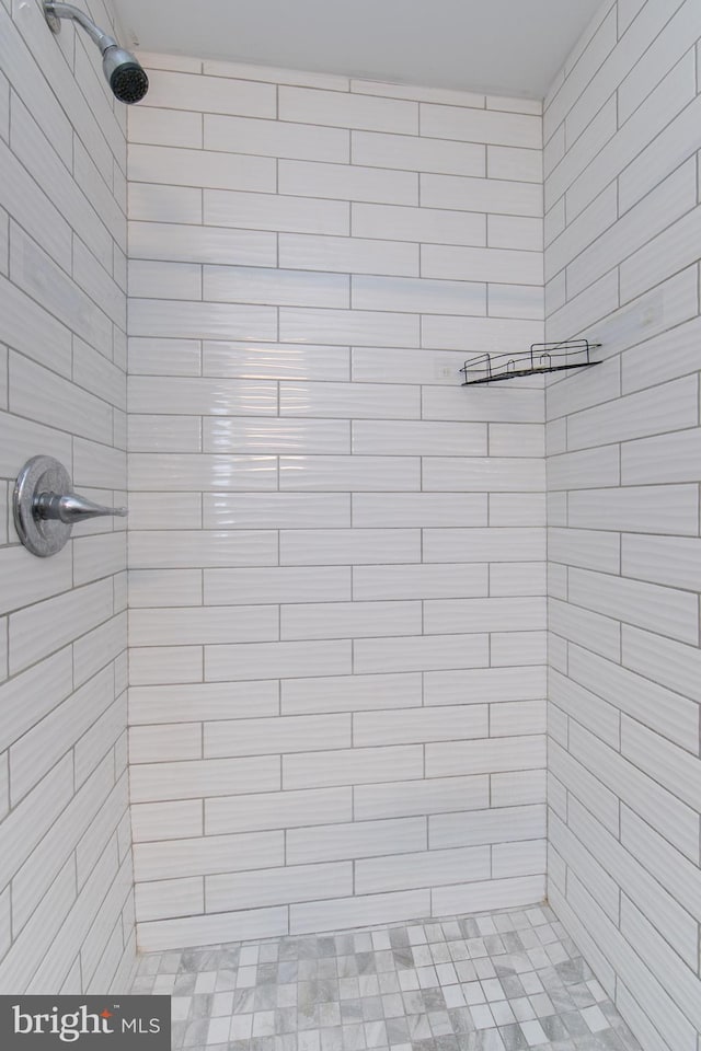 bathroom with tiled shower