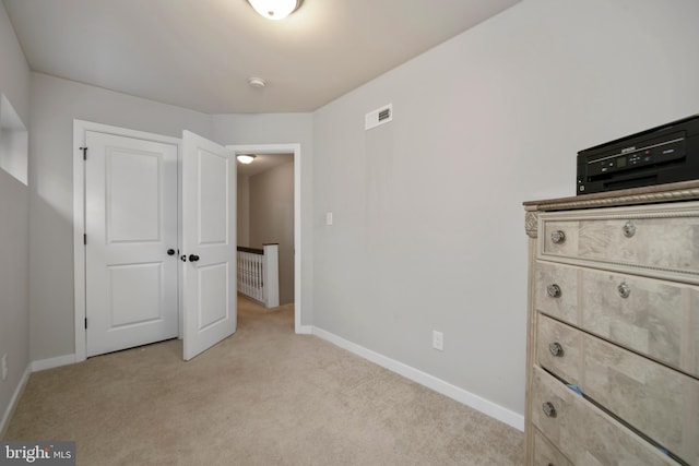 unfurnished bedroom with light colored carpet