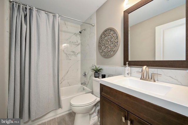 full bathroom featuring shower / tub combo, vanity, tile walls, and toilet