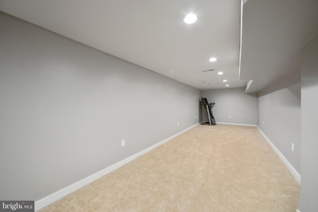 basement featuring light colored carpet