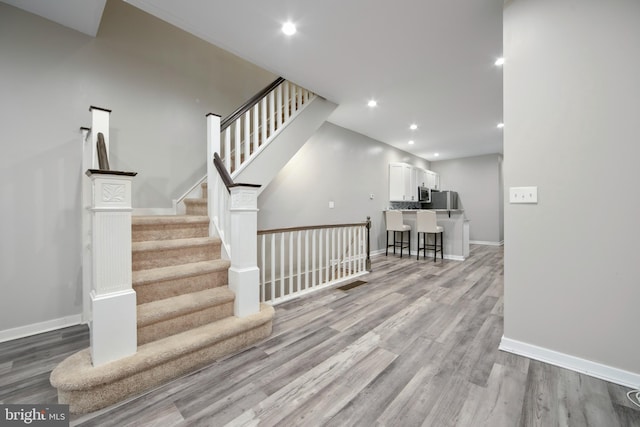 staircase with wood-type flooring