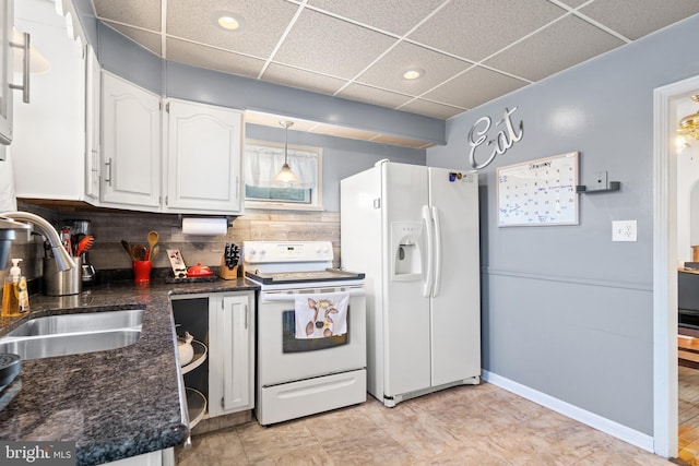 kitchen with sink, hanging light fixtures, white appliances, decorative backsplash, and white cabinets