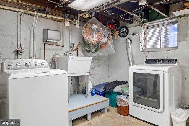 clothes washing area with sink and independent washer and dryer