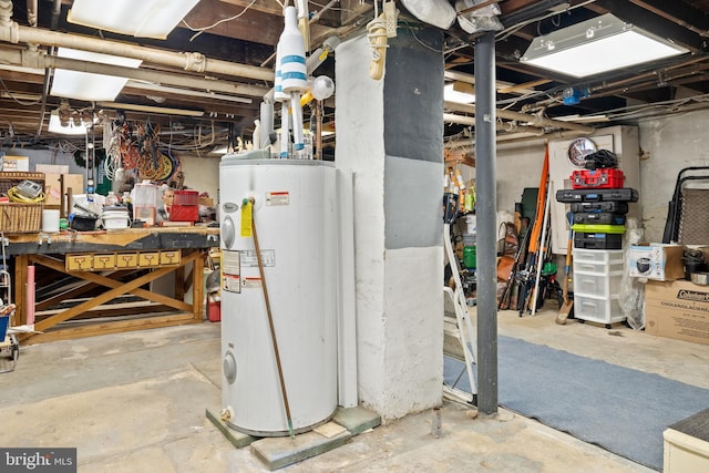 basement with water heater and a workshop area