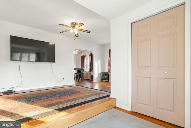 interior space with wood-type flooring and ceiling fan