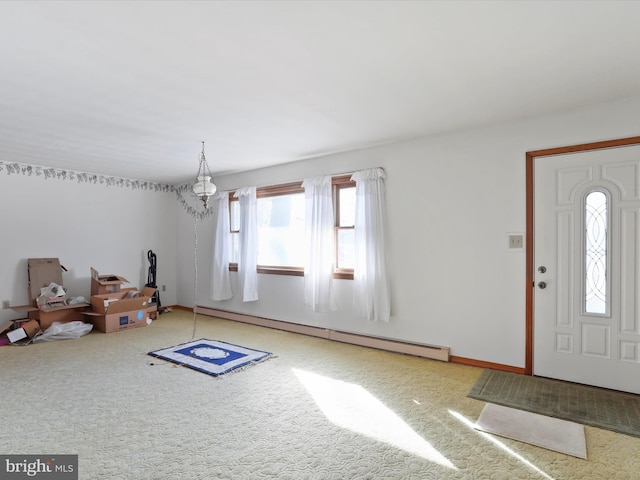 entryway with a baseboard radiator, carpet flooring, and a chandelier