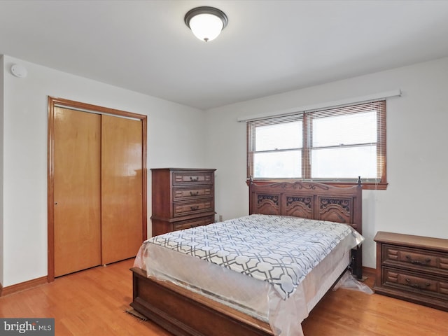 bedroom with a closet and light wood-type flooring