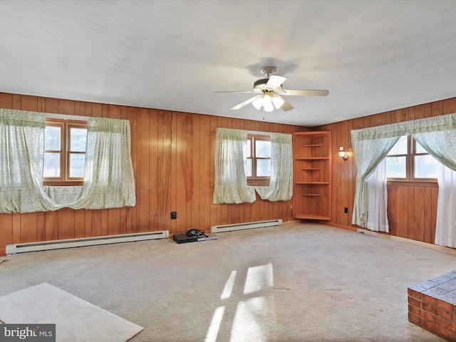 interior space featuring a baseboard radiator, plenty of natural light, and carpet