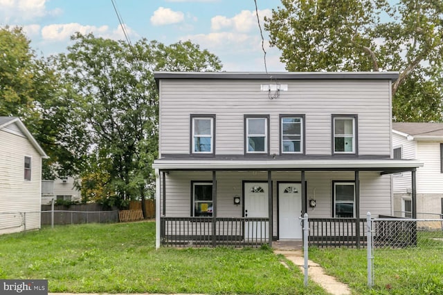 view of front of home featuring a front lawn and covered porch