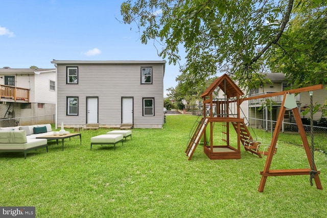 back of house featuring a yard, an outdoor hangout area, and a playground