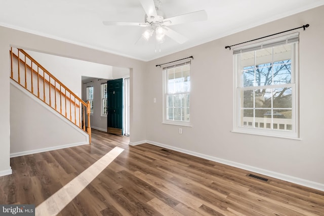 interior space with hardwood / wood-style flooring, ornamental molding, and ceiling fan