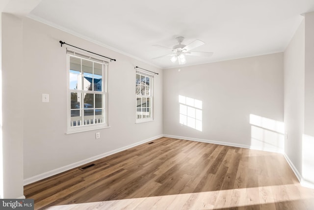 unfurnished room featuring crown molding, ceiling fan, and light wood-type flooring