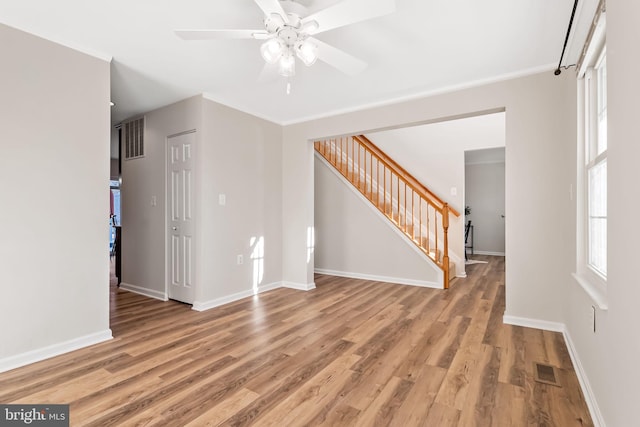 unfurnished room with wood-type flooring, ornamental molding, and ceiling fan