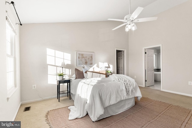 carpeted bedroom featuring high vaulted ceiling and multiple windows