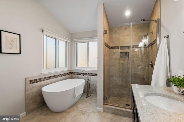 bathroom featuring vanity, separate shower and tub, and lofted ceiling