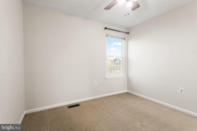 empty room with carpet flooring and ceiling fan