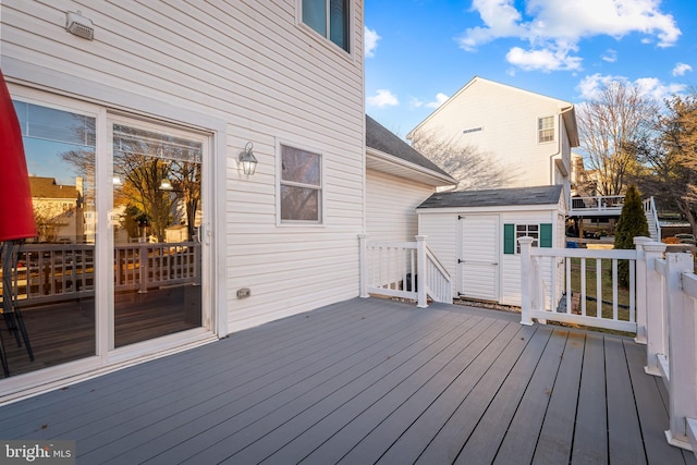 wooden terrace featuring an outdoor structure