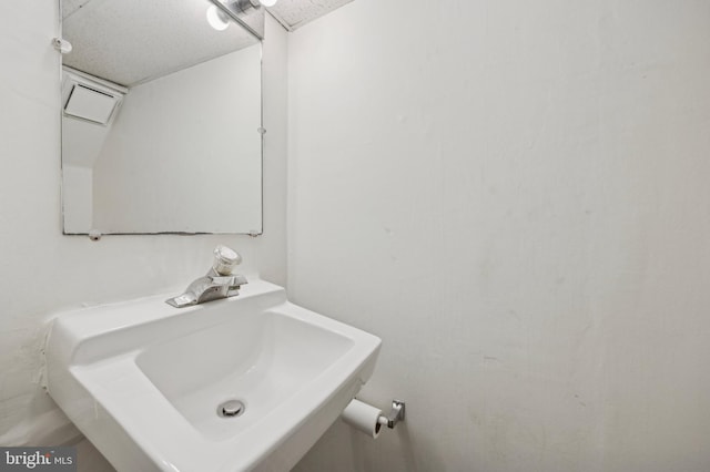 bathroom with sink and a textured ceiling