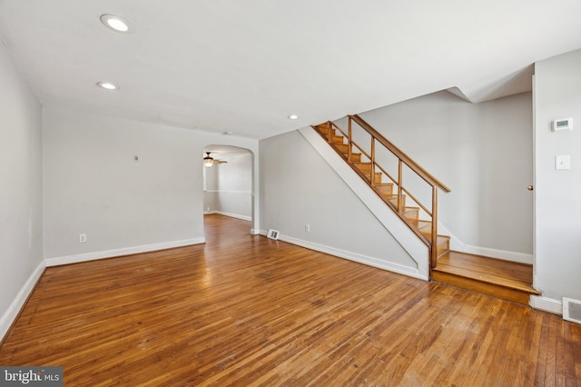 unfurnished living room featuring hardwood / wood-style flooring and ceiling fan