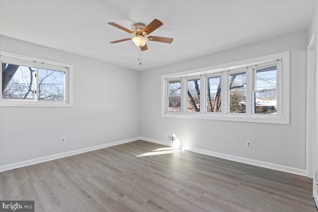 unfurnished room featuring hardwood / wood-style flooring and ceiling fan