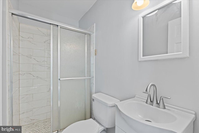 bathroom with vanity, toilet, and a shower with shower door